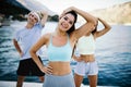 Group of happy people exercising outdoor. Sport, fitness, friendship and healthy lifestyle concept