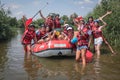 Group of happy people with guide whitewater rafting and rowing on river, extreme and fun sport Royalty Free Stock Photo