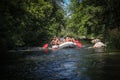 Group of happy people with guide whitewater rafting and rowing on river, extreme and fun sport Royalty Free Stock Photo