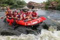 Group of happy people with guide whitewater rafting and rowing on river, extreme and fun sport Royalty Free Stock Photo