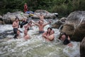 Group of happy people with guide whitewater rafting and rowing on river, extreme and fun sport Royalty Free Stock Photo