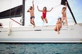 Group of people jumping in the water during a boat Royalty Free Stock Photo