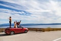 Group of happy people in red convertible car Royalty Free Stock Photo