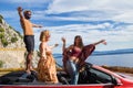 Group of happy people in red convertible car Royalty Free Stock Photo