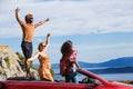 Group of happy people in red convertible car. Royalty Free Stock Photo