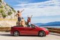 Group of happy people in red convertible car. Royalty Free Stock Photo