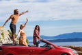 Group of happy people in red convertible car. Royalty Free Stock Photo