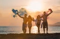 Group of happy people walking on beautiful beach in summer sunset Royalty Free Stock Photo