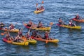 Group of happy people on yellow kayaks