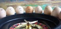 Group of happy and sad eggs friends  make bets gambiling at the toy roulette in the toy casino Royalty Free Stock Photo