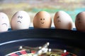 Group of happy and sad eggs friends  make bets gambiling at the toy roulette in the toy casino Royalty Free Stock Photo