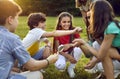 Group of happy school kids learning about environment and insects during field trip Royalty Free Stock Photo