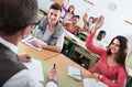 Group of happy school pupils raise their hands up Royalty Free Stock Photo