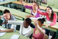 Group of happy school pupils raise their hands up Royalty Free Stock Photo