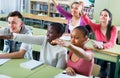 Group of happy school pupils raise their hands up Royalty Free Stock Photo