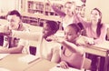 Group of happy school pupils raise their hands up Royalty Free Stock Photo