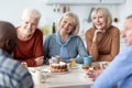 Group of happy senior friends drinking tea with cake together Royalty Free Stock Photo