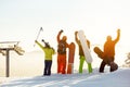 Group of happy skiers and snowboarders having fun