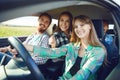 A group of happy friends are driving in a car. Royalty Free Stock Photo