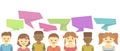 Group of happy smiling kids speaking together. Girls and boys with speech bubbles in different languages map Royalty Free Stock Photo