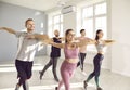 Group of happy, smiling young people having dance fitness workout with instructor Royalty Free Stock Photo