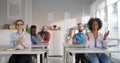 Group of happy students applauding to lecturer while attending class at university classroom. Royalty Free Stock Photo