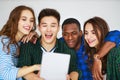 Group of happy students people friends with phones tablets gadgets laugh Royalty Free Stock Photo