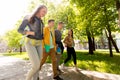 Group of happy teenage students walking outdoors Royalty Free Stock Photo