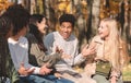 Group of happy teenagers talking and laughing in park Royalty Free Stock Photo