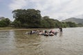 A group of happy tourist relaxing sailing over a blacklifebuoy at Palomino river