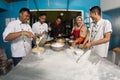 Group of happy young asian pastry chef preparing dough with flour, profesional chef working at kitchen Royalty Free Stock Photo