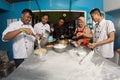 Group of happy young asian pastry chef preparing dough with flour, profesional chef working at kitchen Royalty Free Stock Photo