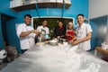 Group of happy young asian pastry chef preparing dough with flour, profesional chef working at kitchen Royalty Free Stock Photo