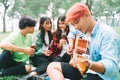 Group of happy young asians having a picnic at the park