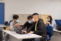 15 11 2021 group of happy young boys and girls with face mask work, discuss, study on assignment and teaching materials together