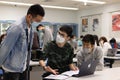15 11 2021 group of happy young boys and girls with face mask work, discuss, study on assignment and teaching materials together