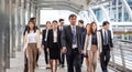 Group of happy young business team, businesspeople walking the outdoor office together success teamwork for concepts Royalty Free Stock Photo