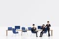 Group of happy young businessmen and businesswoman relaxing meeting talking working in office, 3D rendering Royalty Free Stock Photo