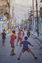 Group of happy, young children playing in the street in a vibrant Cuban neighborhood