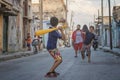 Group of happy, young children playing in the street in a vibrant Cuban neighborhood Royalty Free Stock Photo