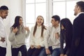 Group of happy young coworkers, students or friends talking about funny stuff and laughing Royalty Free Stock Photo