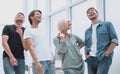 Group of happy young employees standing in the office