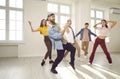 Group of happy young men and women having a dancing class in a modern dance studio Royalty Free Stock Photo