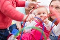 Group of happy young mothers watching their cute and healthy babies play Royalty Free Stock Photo