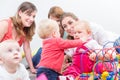 Group of happy young mothers watching their cute and healthy babies