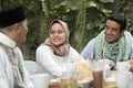 Group of happy young muslim having dinner outdoor