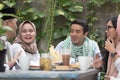 Group of happy young muslim having dinner outdoor during ramadan