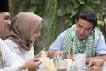 Group of happy young muslim having dinner outdoor during ramadan