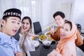 Muslim people taking selfie photo in dining room