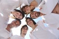 Group of happy young people in circle at beach Royalty Free Stock Photo